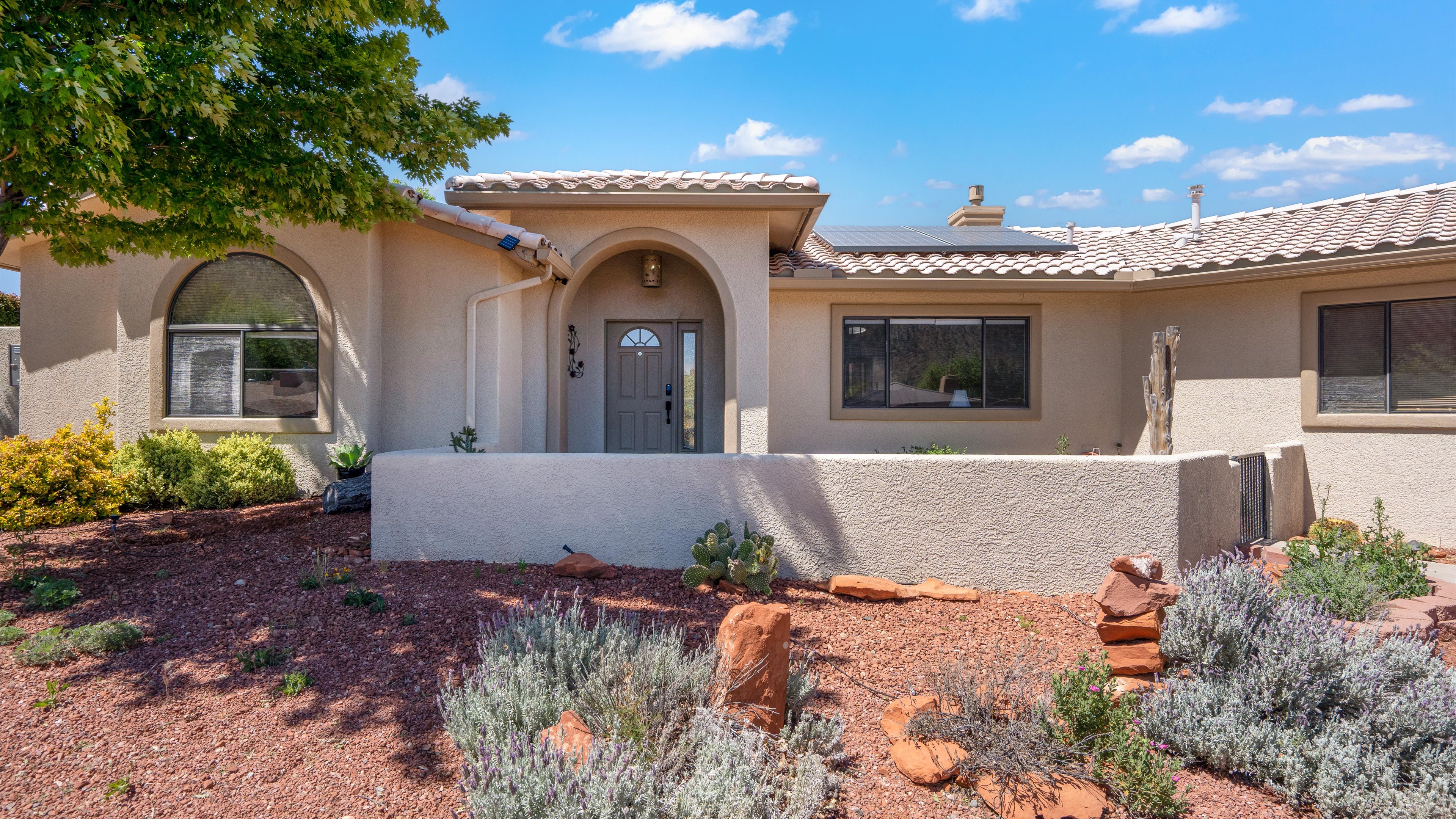 Living room with high ceilings and red rock views